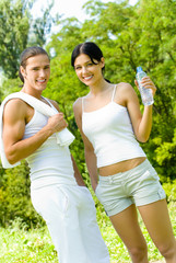 Couple with bottle of water on workout, outdoors