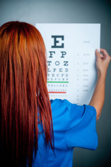 a doctor watching a test for eye examination