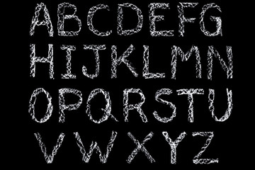 White chalk handwritten letters alphabet on blackboard