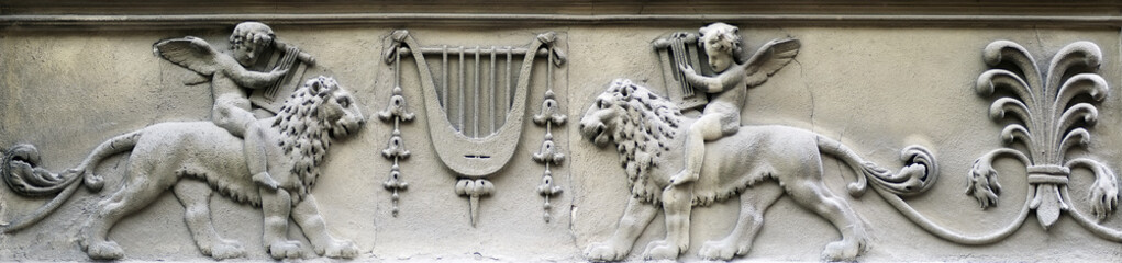 Bas-relief - boy sitting astride a lion