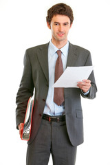 Modern businessman with folder and document in hand