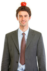 Modern businessman with apple on head