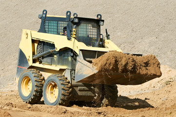 skid steer loader at earth moving works