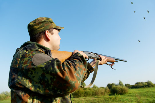 hunter shooting with rifle gun