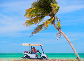 Golf cart at tropical beach © TravelPhotoBloggers