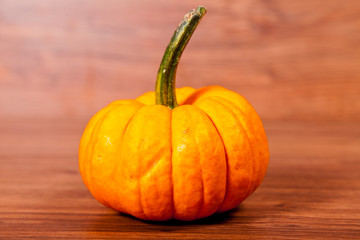 Ripe pumpkin fruits on wooden background