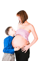 The son of a pregnant mother hugging her belly