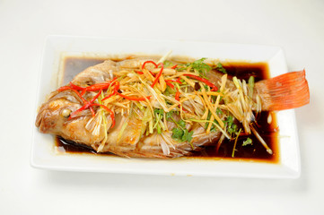 Chinese style marinated steamed fish with onion