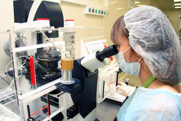Young female doctor working with a microscope in a laboratory