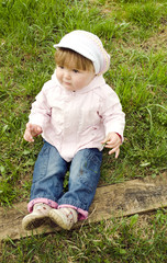 A girl sitting on grass