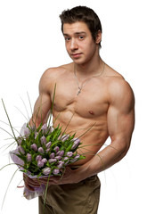 Muscle sexy naked young man hold the bunch of flowers in hand