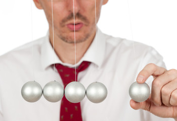 businessman hand with newton's cradle