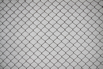 iron net and white cement wall