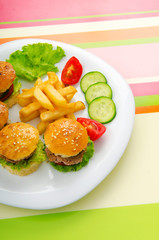 Plate with tasty mini burgers