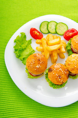 Plate with tasty mini burgers