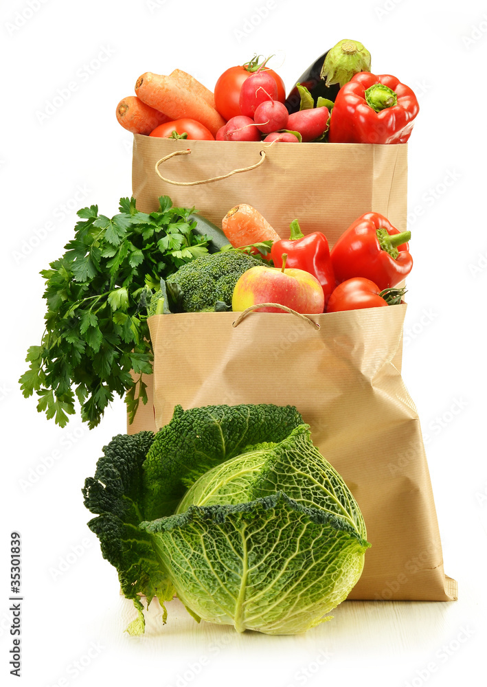 Wall mural Raw vegetables and shopping bag isolated on white