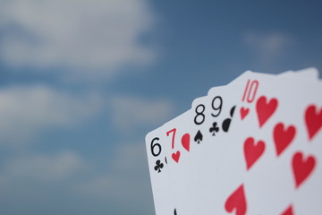 Poker hand - Straight Flush, with sky background