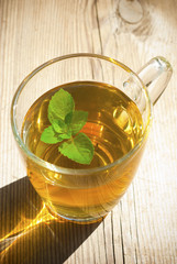 mint tea and mint leaf on old wooden table