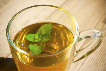 mint tea and mint leaf on old wooden table