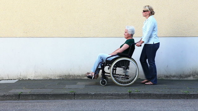 Nurse with disabled senior woman