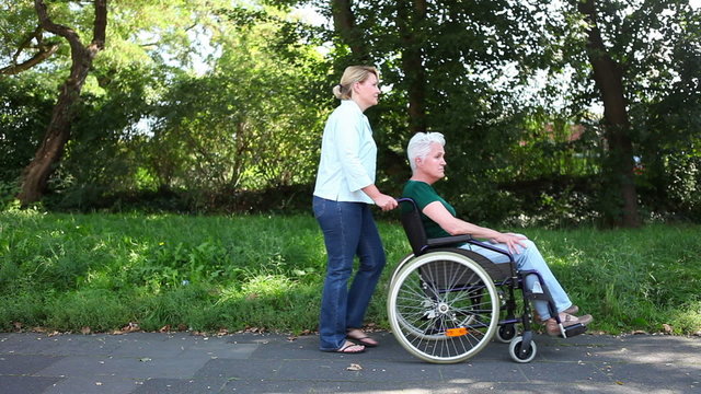 Disabled woman in wheelchair in park