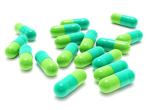 Many two-colored pills on white