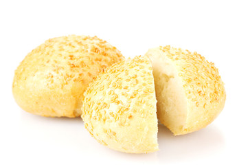 tasty sliced buns with sesame seeds isolated on white