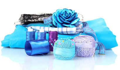 bright blue yarn, fabric, satin ribbon and measuring tape