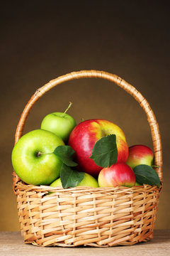 Basket of organic apples on brown background