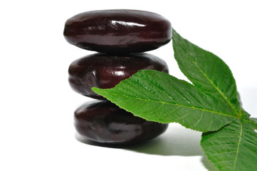 Black stones and a leaf