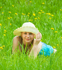 girl in hat relaxing in grass