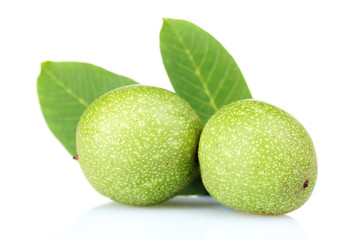 green walnuts and leaves isolated on white