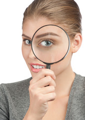 Woman looking through a magnifying glass