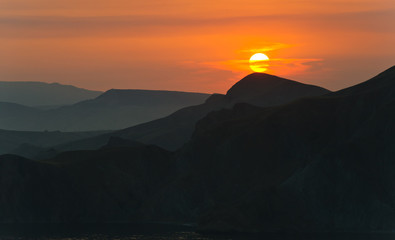 Colourful decline over mountains and the sea.