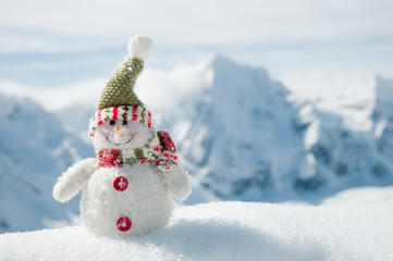 Happy snowman - snowy mountains in background