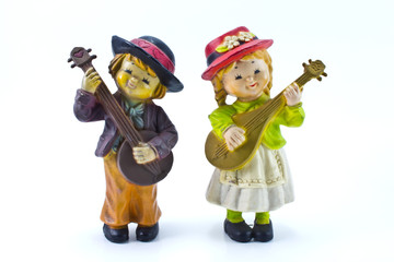 couple of cute child figure playing music
