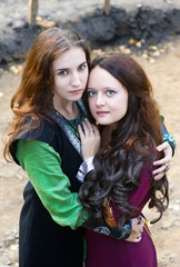 Fototapeta premium Two woman with green eyes hugging