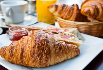 Breakfast with coffee and croissants on table