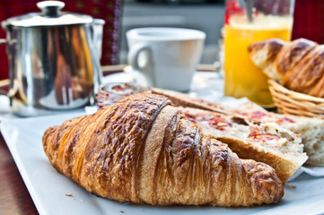 Breakfast with coffee and croissants on table