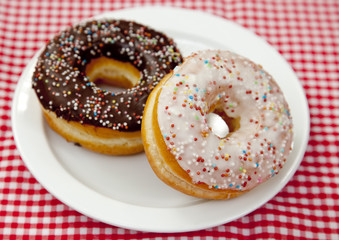 A couple of donuts on table.