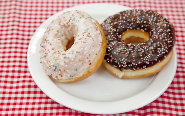 A couple of donuts on table.