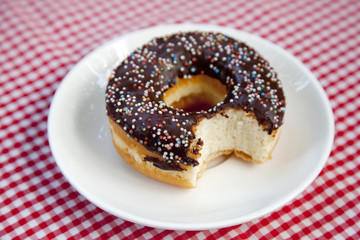Cut donut on table.