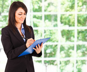 Fototapeta premium Businesswoman writing some documents