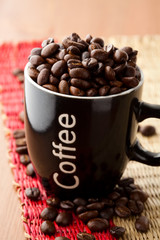 Coffee mug with coffee beans