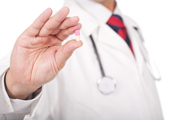 doctor holding a small pill