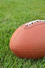 Close-up of an American Football on Grass Field