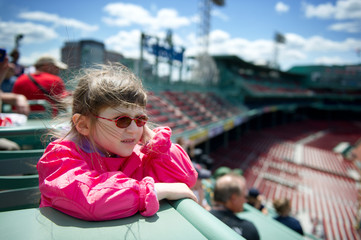 Little girl visiting a baseball park