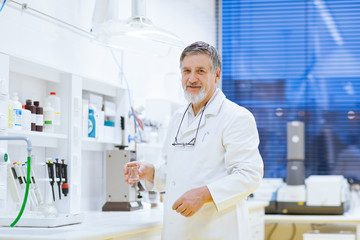 senior male researcher carrying out scientific research in a lab