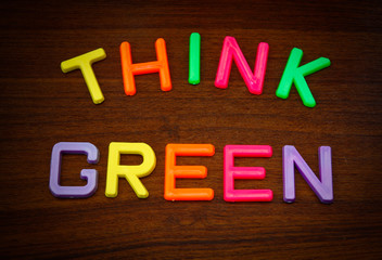 Obraz premium Think green in colorful toy letters on wood background