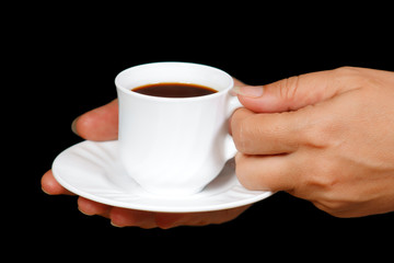 Hands with a cup of coffee on a black background